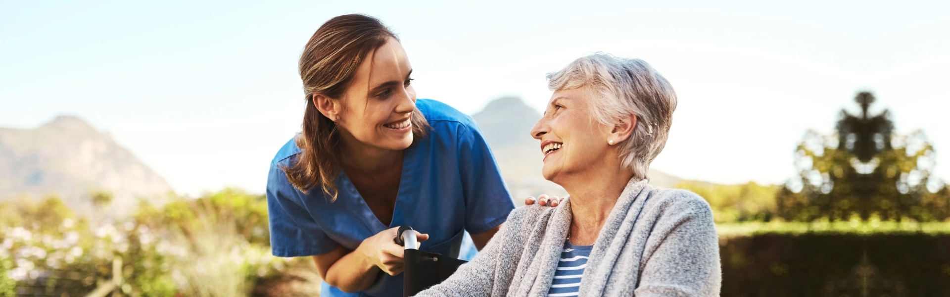 caregiver and elderly smiling at eachother